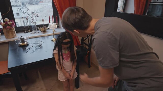 Father scolding daughter at home for bad behavior