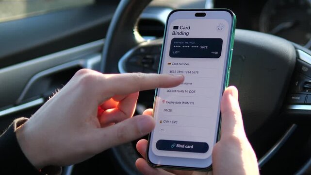 Modern fintech app interface for credit card binding. User enters payment details on a smartphone inside a car. Sleek UI for secure online transactions. Perfect for e-commerce, banking, and mobile