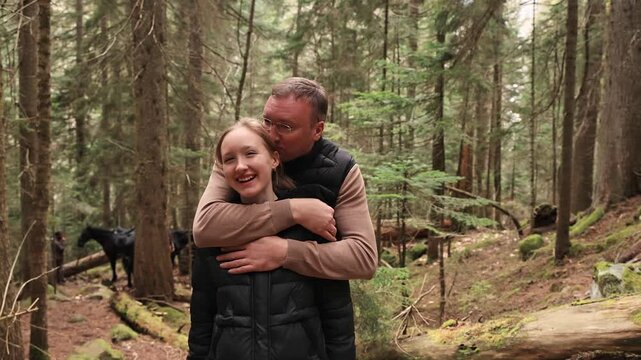 Portrait of daughter and father in a mountain forest.