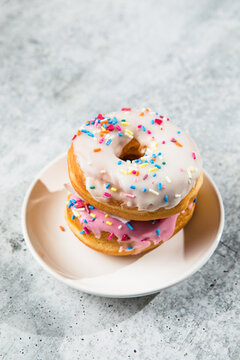 Glazed and decorated donuts showcasing a variety of flavors and toppings, with vibrant icing colors, perfect for a sweet treat or dessert