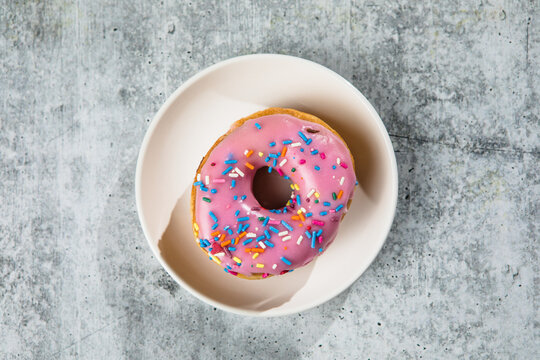 Glazed and decorated donuts showcasing a variety of flavors and toppings, with vibrant icing colors, perfect for a sweet treat or dessert