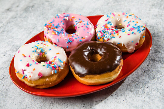 Glazed and decorated donuts showcasing a variety of flavors and toppings, with vibrant icing colors, perfect for a sweet treat or dessert