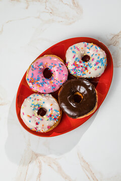 Glazed and decorated donuts showcasing a variety of flavors and toppings, with vibrant icing colors, perfect for a sweet treat or dessert