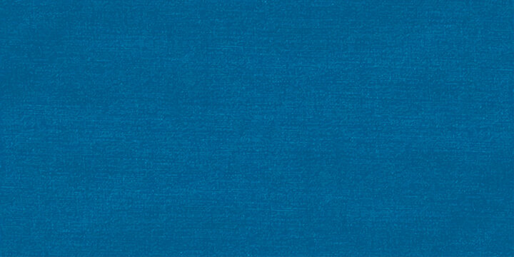 A dark vintage denim material with a rough blue canvas texture and grunge cotton fabric pattern creates a blank textured textile background for an artistic paper wallpaper surface