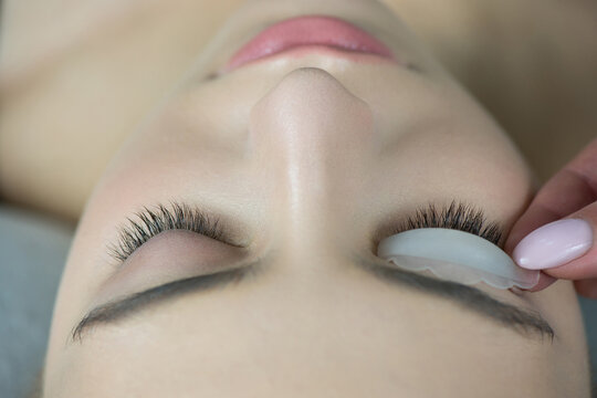 Close up of beauty model's face with perfect fresh skin and long eyelashes, lash lift laminate procedure.