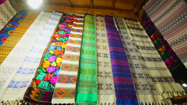 Typical and colorful outfits of the tribes of Guatemala, featuring the quetzal bird