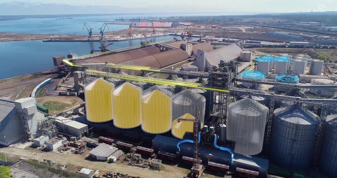 Port grain elevator. Silos for grain storage and processing. Drone aerial view. The metal granary tanks. Grain Terminal System for Grain Storage and Transportation. Smart industry.