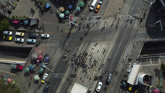 Top view of the vehicular and pedestrian flow at the intersection of Calzada Independencia and Avenida Ju&aacute;rez. Pedestrians cross the street while vehicles turn around. Guadalajara, M&eacute;xico