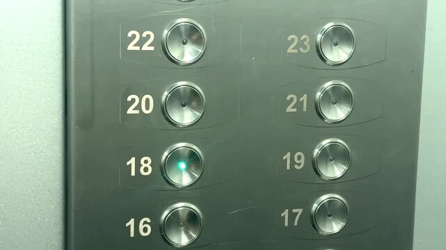 Panel of elevator buttons with floor numbers from 16 to 22, illuminated indicators in a modern lift. elevator panel, floor buttons, lift control, high-rise building, vertical transport.