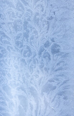 Obraz premium Delicate frost patterns forming on a cold window surface