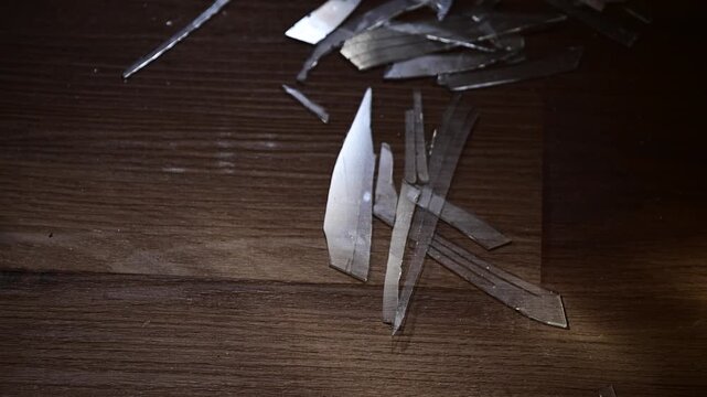Broken shuddered glass on a floor selective focus handheld video close up of broken glass cinematic look