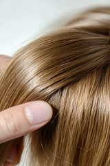 Fototapeta premium A woman is brushing her hair with a brush