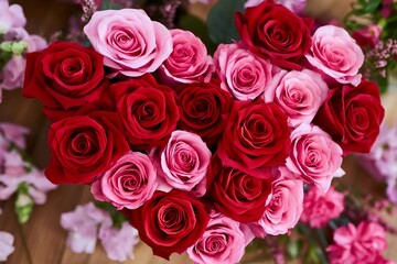 Obraz premium Heart Shape Made of Red and Pink Roses on a Wooden Surface