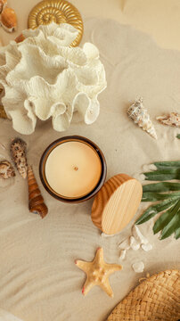 Serene beachside ambiance with a candle, seashells, and coral decor