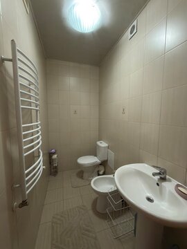 Modern bathroom with toilet sink bidet and heated towel rail