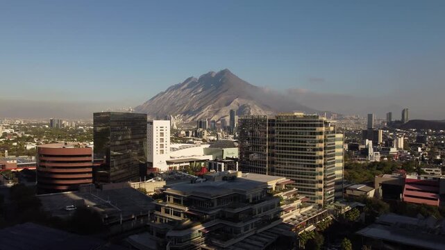 Aerial drone panoramic view of Cerro de la Silla mountain with morning mist and Monterrey city skyline Nuevo Leon Mexico