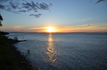 Fototapeta premium Sunset over Guaíba Lake with golden reflection on water in Porto Alegre Brazil