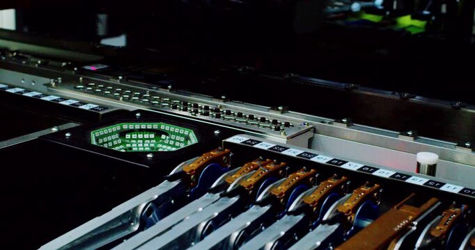 Modern high-tech production: Close-up of an automated high-precision machine assembling an electronic printed circuit board.