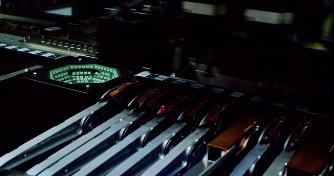Modern high-tech production: Close-up of an automated high-precision machine assembling an electronic printed circuit board.