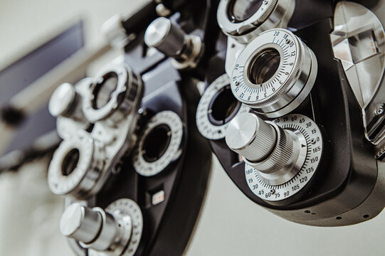 Professional ophthalmic refractor for measuring visual acuity. Technical view of a phoropter highlighting the mechanical complexity of vision correction instruments.
