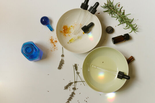 Herbs and essential Oils on a Surface With Tools for Mixing 