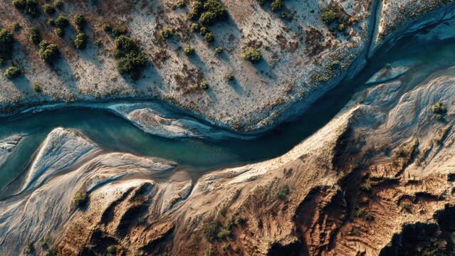 Aerial View of Winding River Through Arid Landscape
