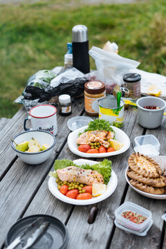 Wooden table set with delicious meal outdoors