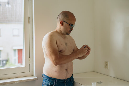 Diabetic man preparing a glucometer. 