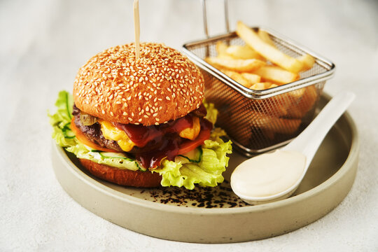 Neat burger with French fries, served in restaurant