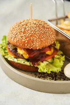 Neat burger with French fries, served in restaurant