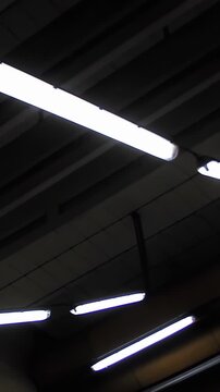 Moving Vertical View of Symmetric Fluorescent Lamps in Prague Underground - 4K