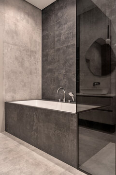 Bathroom in contemporary style with tiled walls