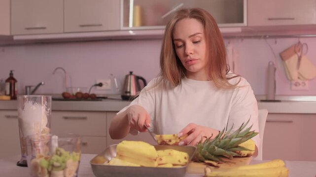 Closeup of pineapple slicing process. Hands expertly cutting pineapple into rings. Closeup footage showcasing detailed process of preparing fresh pineapple for cooking