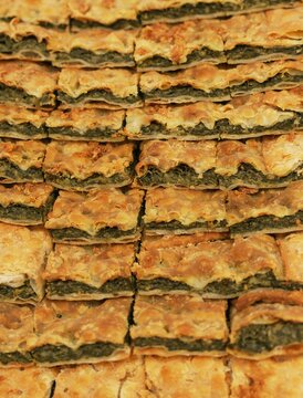 A delicious and rustic erbazzone reggiano, a classic Italian pastry filled with herbs and greens, presented in a neat grid of portions