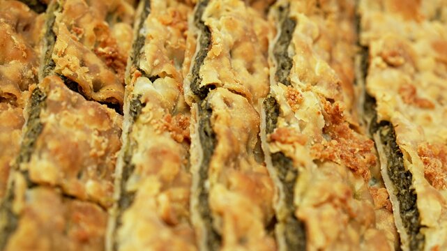 A delicious and rustic erbazzone reggiano, a classic Italian pastry filled with herbs and greens, presented in a neat grid of portions