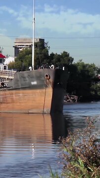 Old Rusty Mooring Bollard and Decaying Vessel in La Boca District, Buenos Aires - Vertical Video 4K