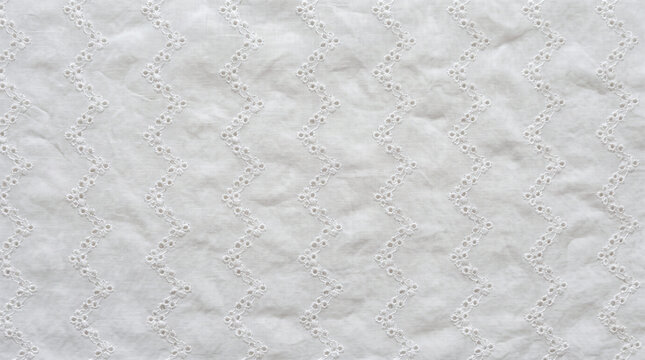 White textile with vertical zigzag eyelet embroidery pattern