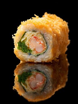 Fried sushi roll featuring shrimp, crab stick, and rice on a black background