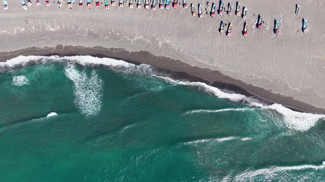 Aerial zenith view of artisanal fishing boats on Curanipe beach, Chile.