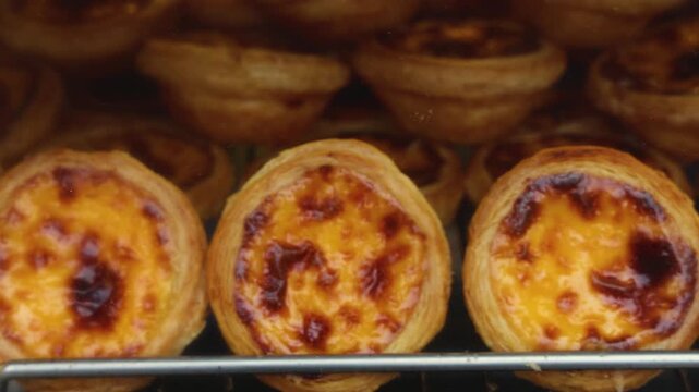 Pasteis and Pastel de nata, traditional Portuguese egg custard tart pasty cakes, dessert Pasteis de nata with different pastry in the cafe, bakery display window, Pastel de belem, Lisbon, Portugal