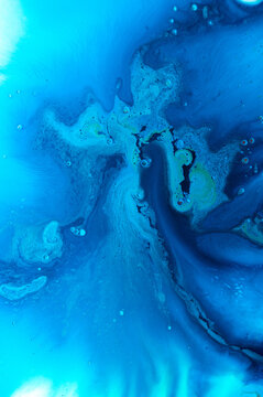Bright blue abstract pattern with shapes and textures in fluid art style