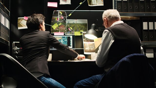 Detectives rushing to catch culprit, finding out about criminal whereabouts over office phone call. Team of inspectors running to capture killer suspect with incriminating proof. Handheld shot.