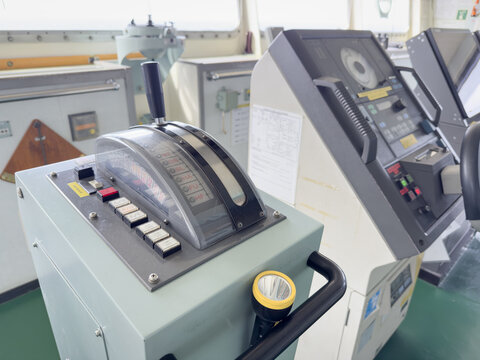 auto pilot and engine telegraph. cargo ship bridge equipment. ship in route. full ahead. automatically  steering course