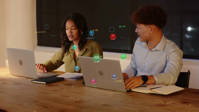 Floating data icons appearing on laptops urging woman and man shifting focus to screen, data review