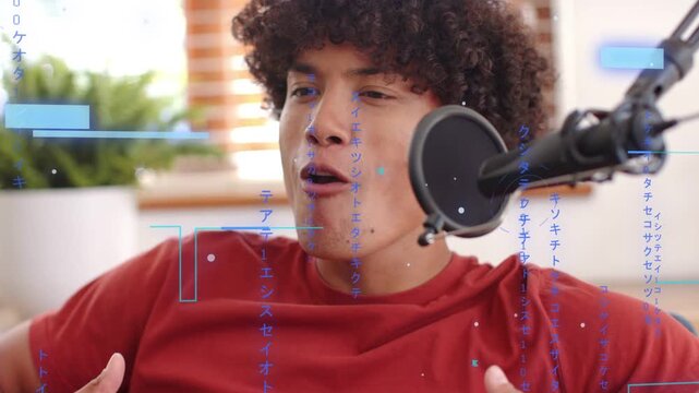 Leaning forward, man in red tee recording content, gesturing in home studio with mic, blue overlays