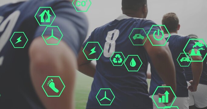 Running athletes in navy jerseys showing 8 with shorts on grassy pitch, with green hexagonal icons