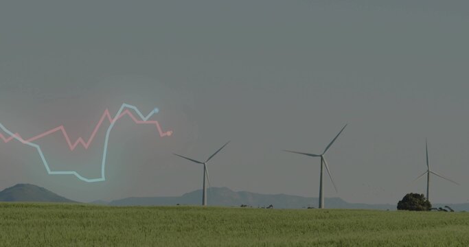 Showing three white wind turbines turning over rural wind farm, with distant hills, shrub, graph