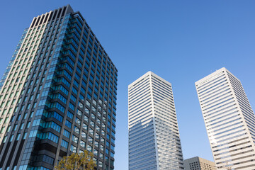 Fototapeta premium Osaka city office tower with modern architecture and blue sky