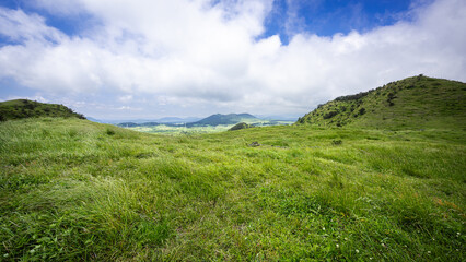 Fototapeta premium The weather was clearing up in the strong wind! Unique landscape of Geomi-Oreum(small extinct volcano) in spring, Jeju Island, South Korea.