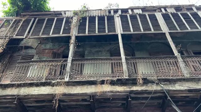 Colonial-era heritage: A 19th-century residential balcony in West Bengal, showcasing iconic red-brick flooring and retro balustrades typical of aristocratic mansions.